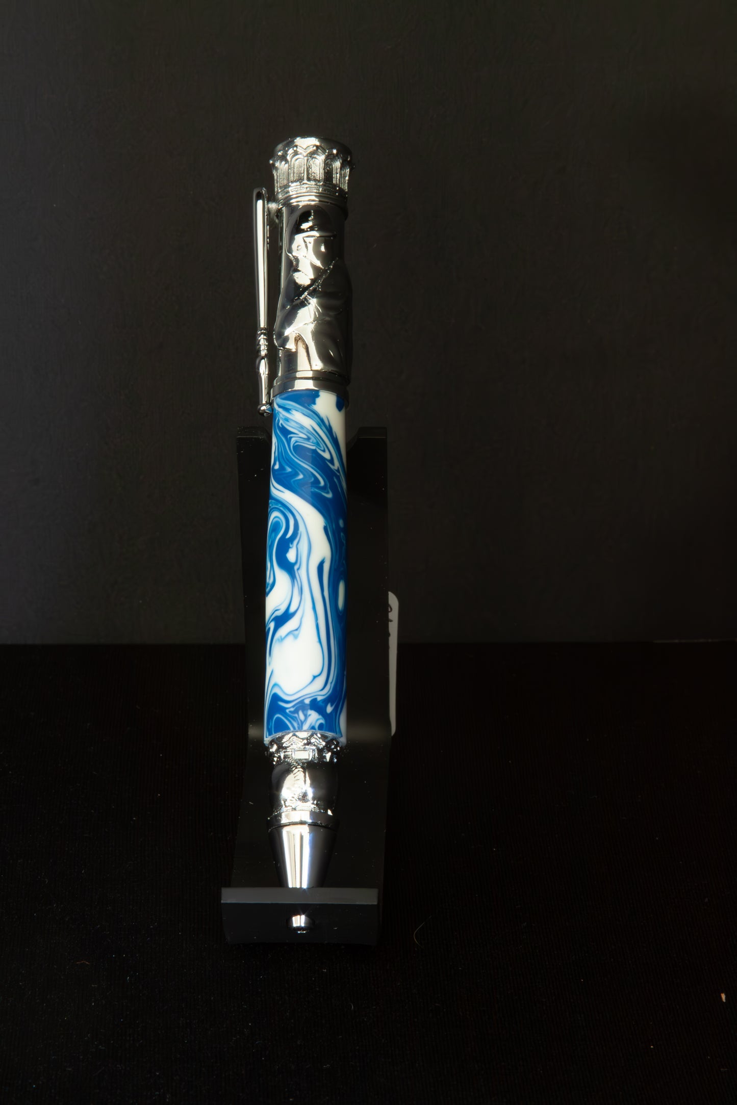 Decorative Baseball pen with blue and white design on a black background