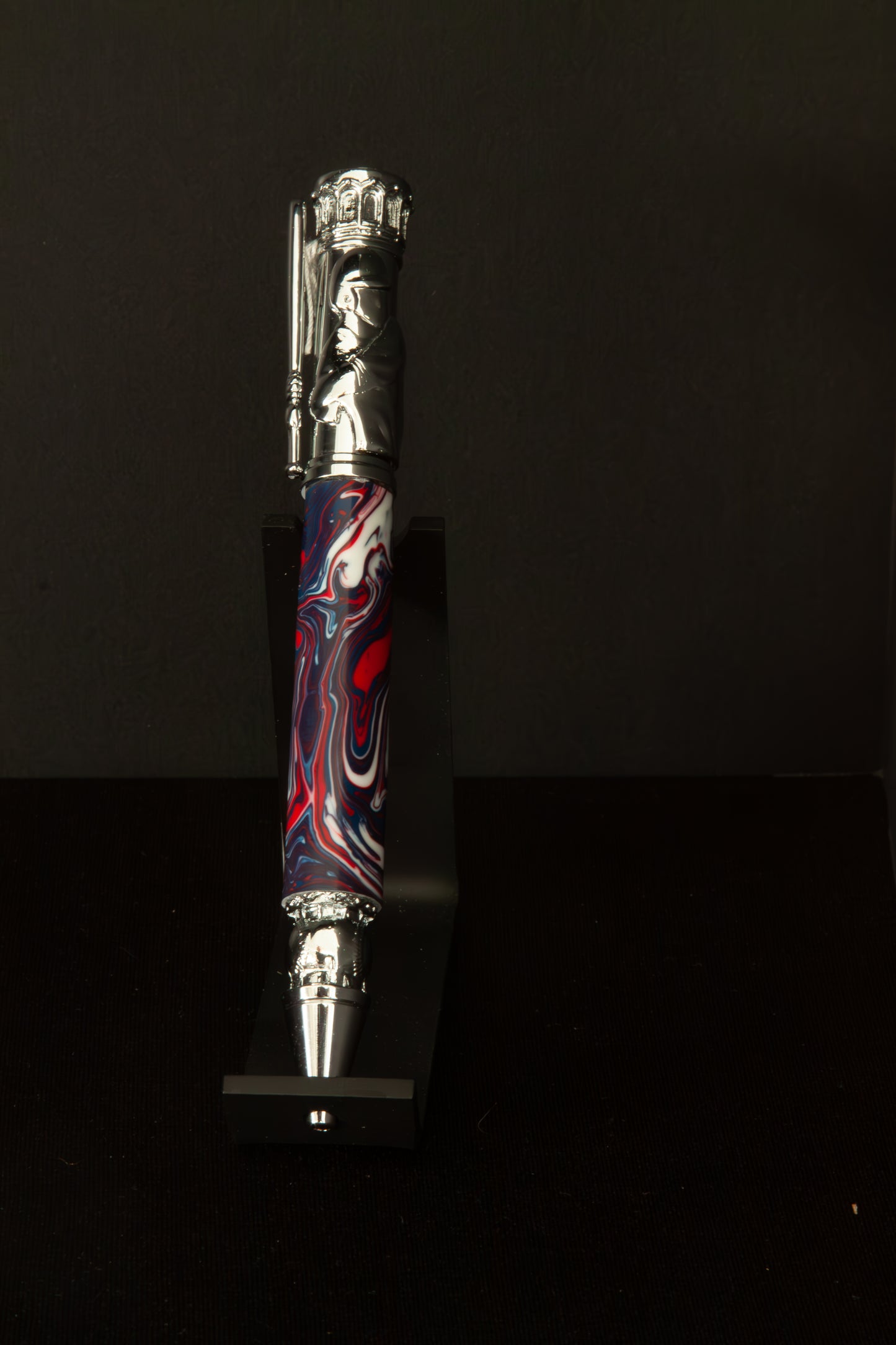 Decorative Baseball pen with red, white and blue design on a black background