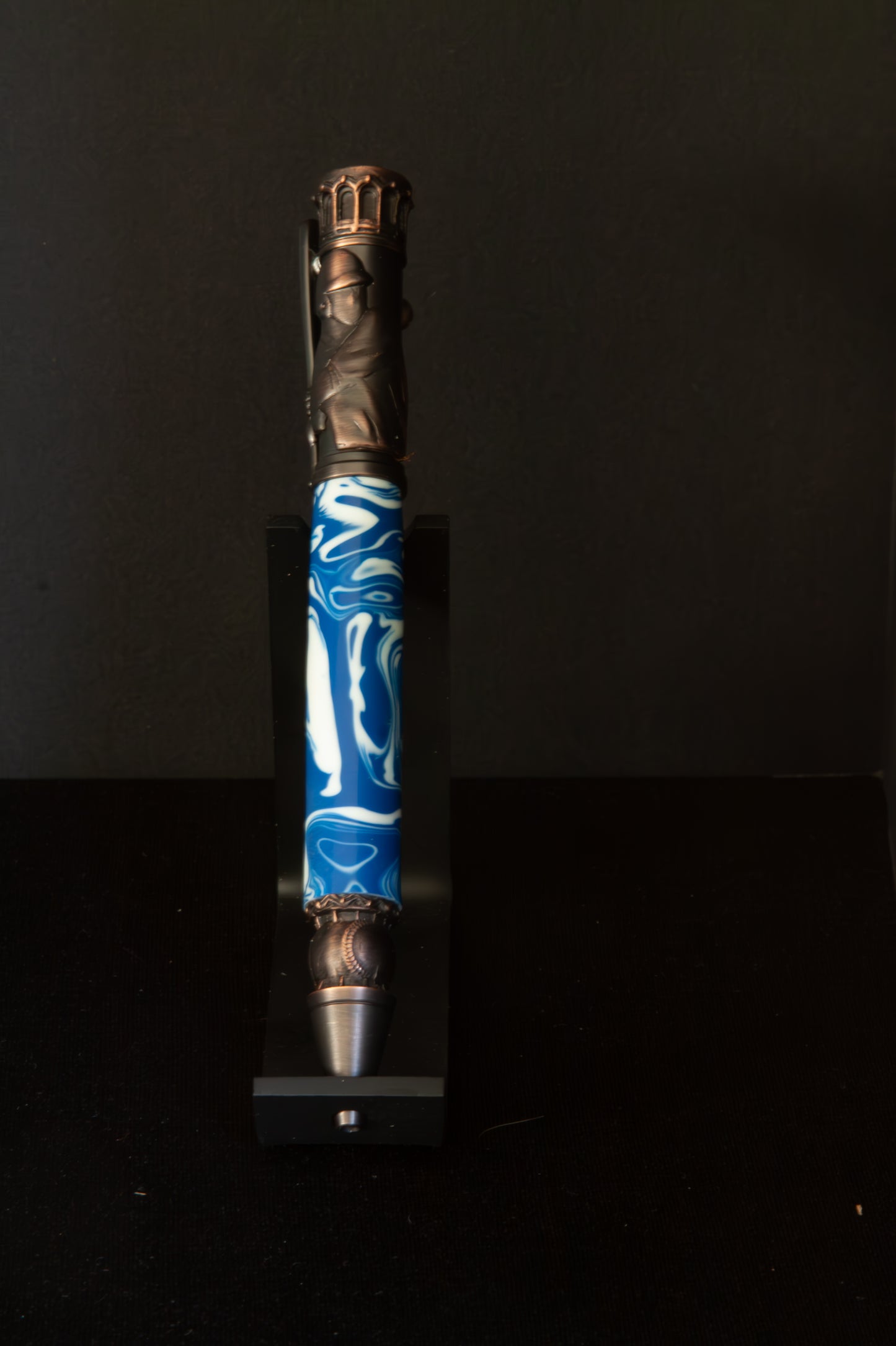 Decorative Baseball pen with blue and white design on a black background