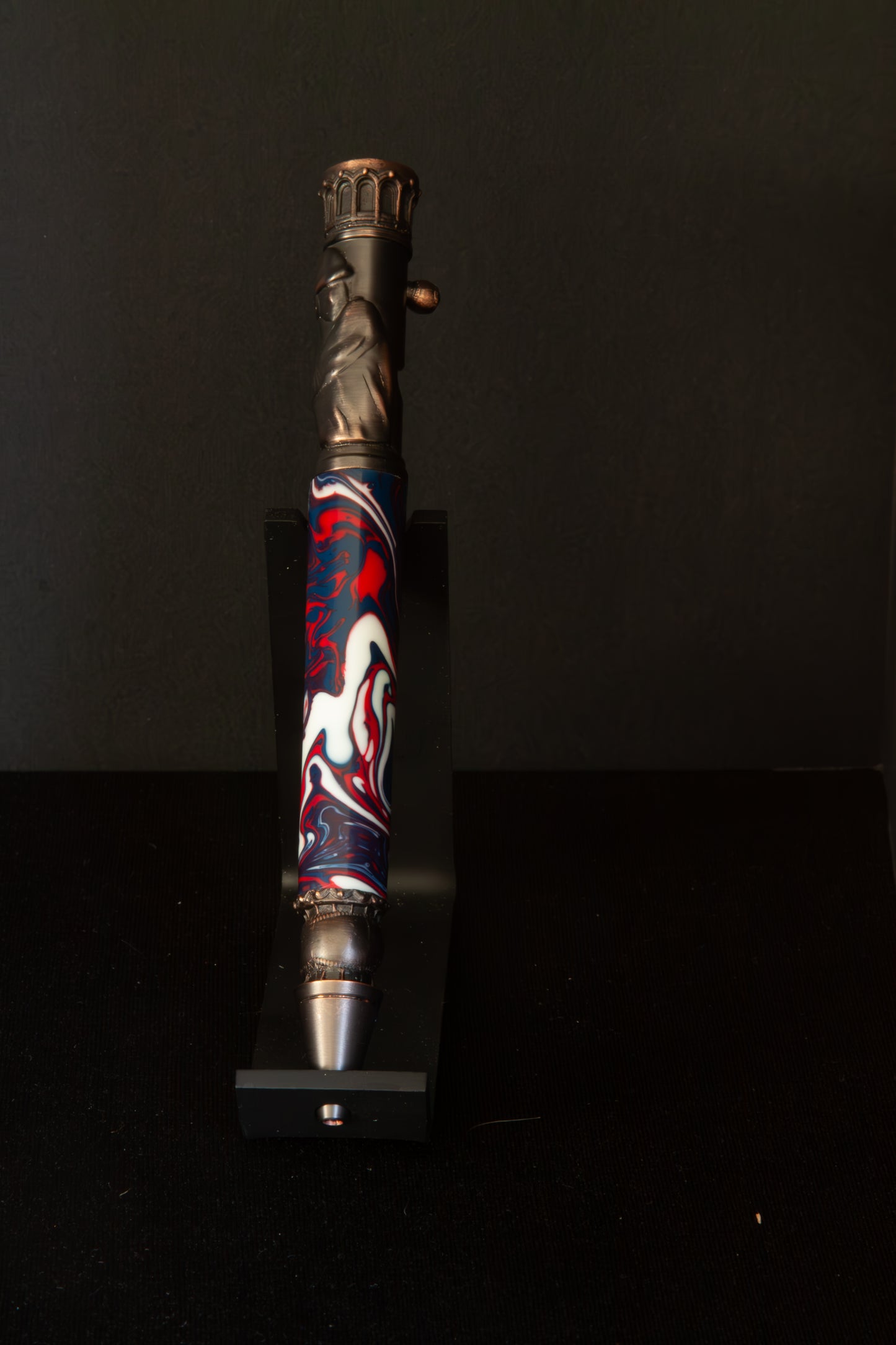 Decorative Baseball pen with red, white and blue design on a black background