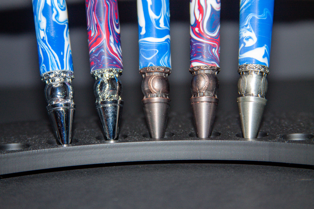 Five Baseball pens with marbled blue and red design showing baseball tips on a black background